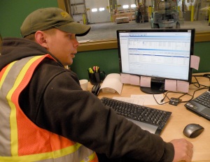 Photo by Jenny Neyman, Redoubt Reporter. Boyd Jorgensen, operations manager in Soldotna, demonstrates the routing software used to keep track of trucks, schedules, routes, freight and other details of Lynden Transit’s operations. In an effort to be more energy-efficient companywide, the Soldotna site is pioneering new and enhanced practices, like planning routes as efficiently as possible, to save time and fuel.