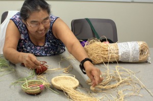 Rose Guilbeau, of Kenai, displays several baskets she has begun working on while attending one of the center’s arts and crafts classes Monday.