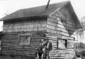 Photo courtesy of the KPC Historical Photo Archive. Howard and Maxine Lee pose with their children, Karen and Michael, next to their Soldotna homestead cabin in 1950. 